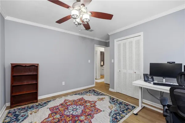 a view of a livingroom with workspace and a window
