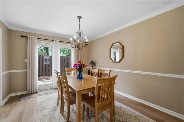 a view of a dining room with furniture and a chandelier