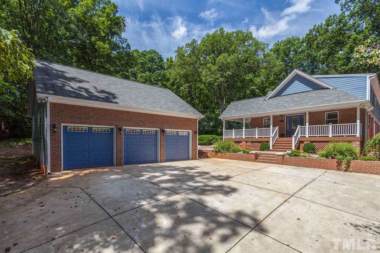 This 3 Bay Car Garage has a Single Door in the Back to pull through car/boat.  Also, has a Lift to haul items up for Storage in 2nd Story of Garage.