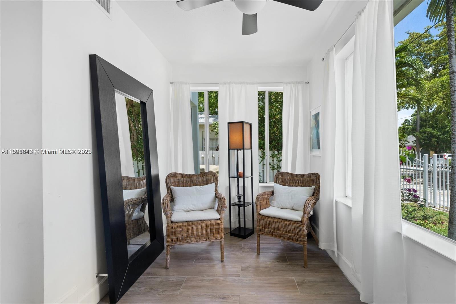 555 Northeast 70th Street Miami, FL 33138 - Photo 1 of 19 a living room with furniture and a gate