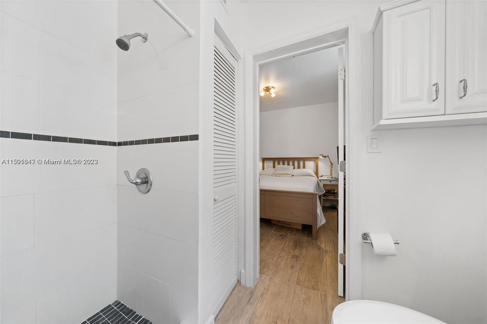 555 Northeast 70th Street Miami, FL 33138 - Photo 12 of 19 a bathroom with a toilet and a shower