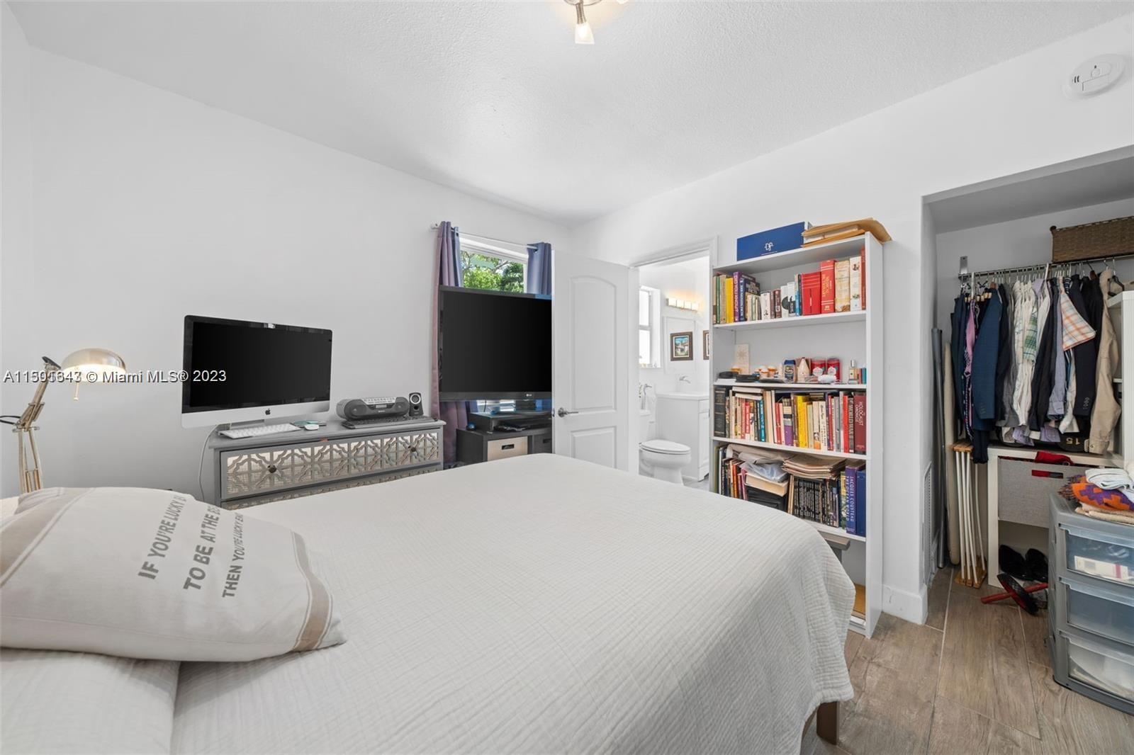 555 Northeast 70th Street Miami, FL 33138 - Photo 14 of 19 a bedroom with a bed and a flat screen tv