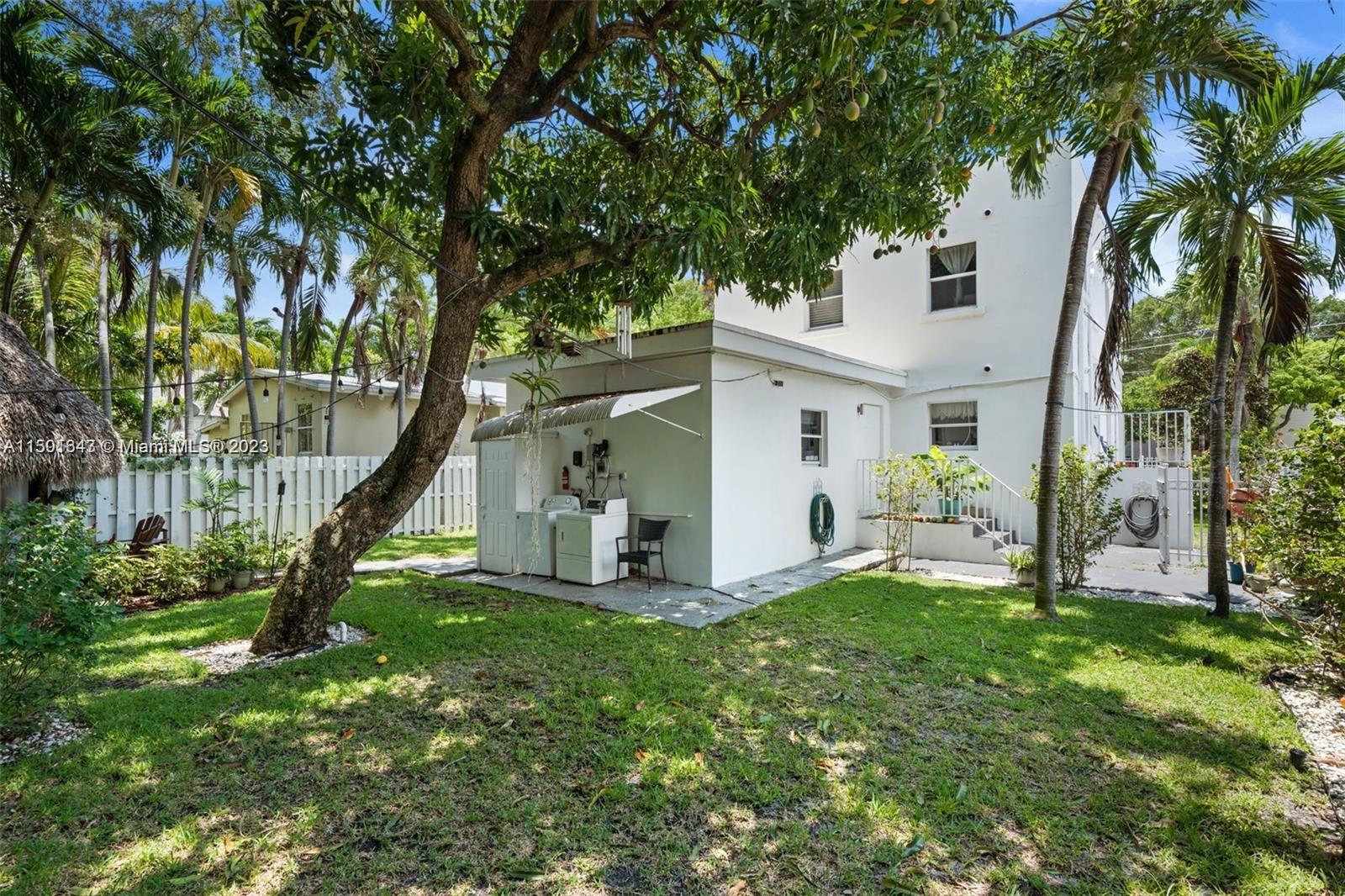 555 Northeast 70th Street Miami, FL 33138 - Photo 16 of 19 a view of a house with backyard and a tree