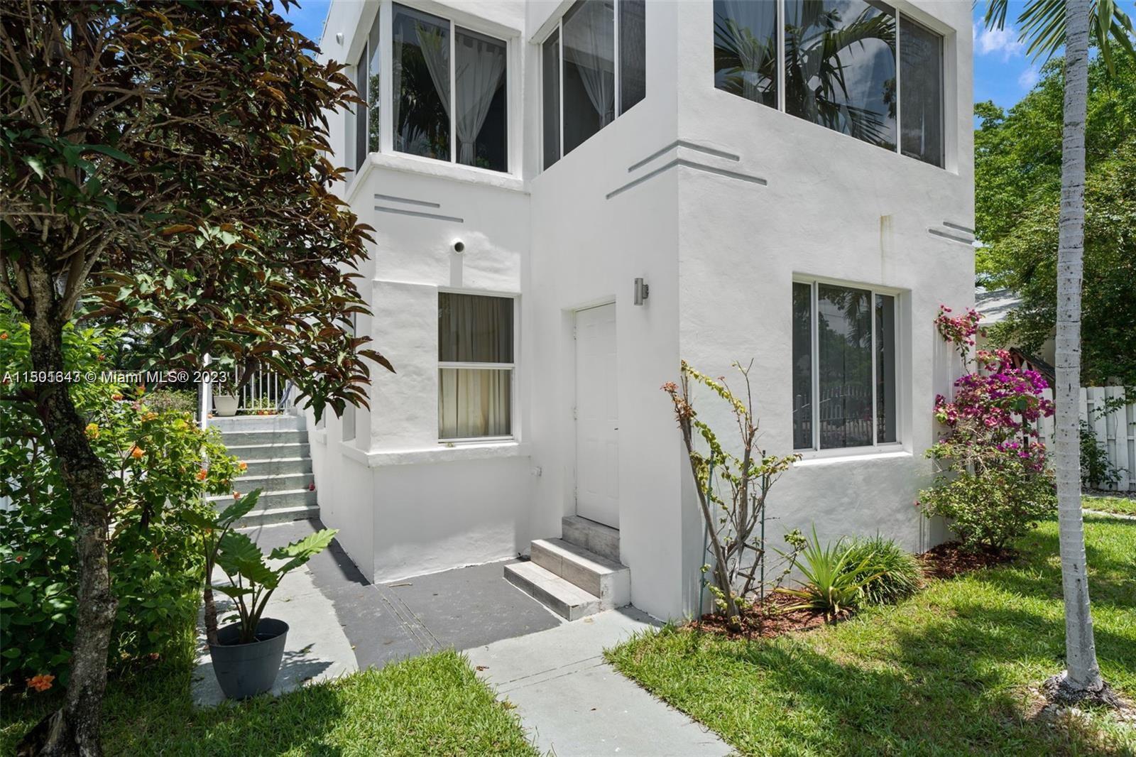555 Northeast 70th Street Miami, FL 33138 - Photo 18 of 19 a front view of a house with garden