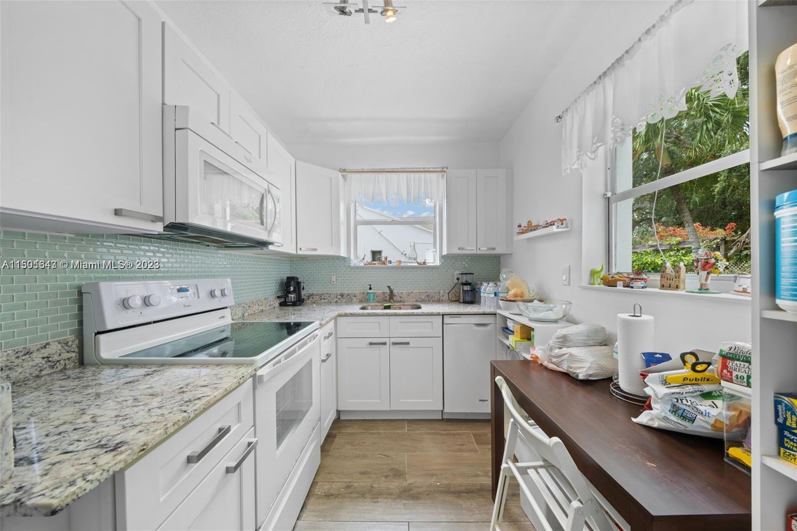 555 Northeast 70th Street Miami, FL 33138 - Photo 5 of 19 a kitchen with a sink a window and cabinets