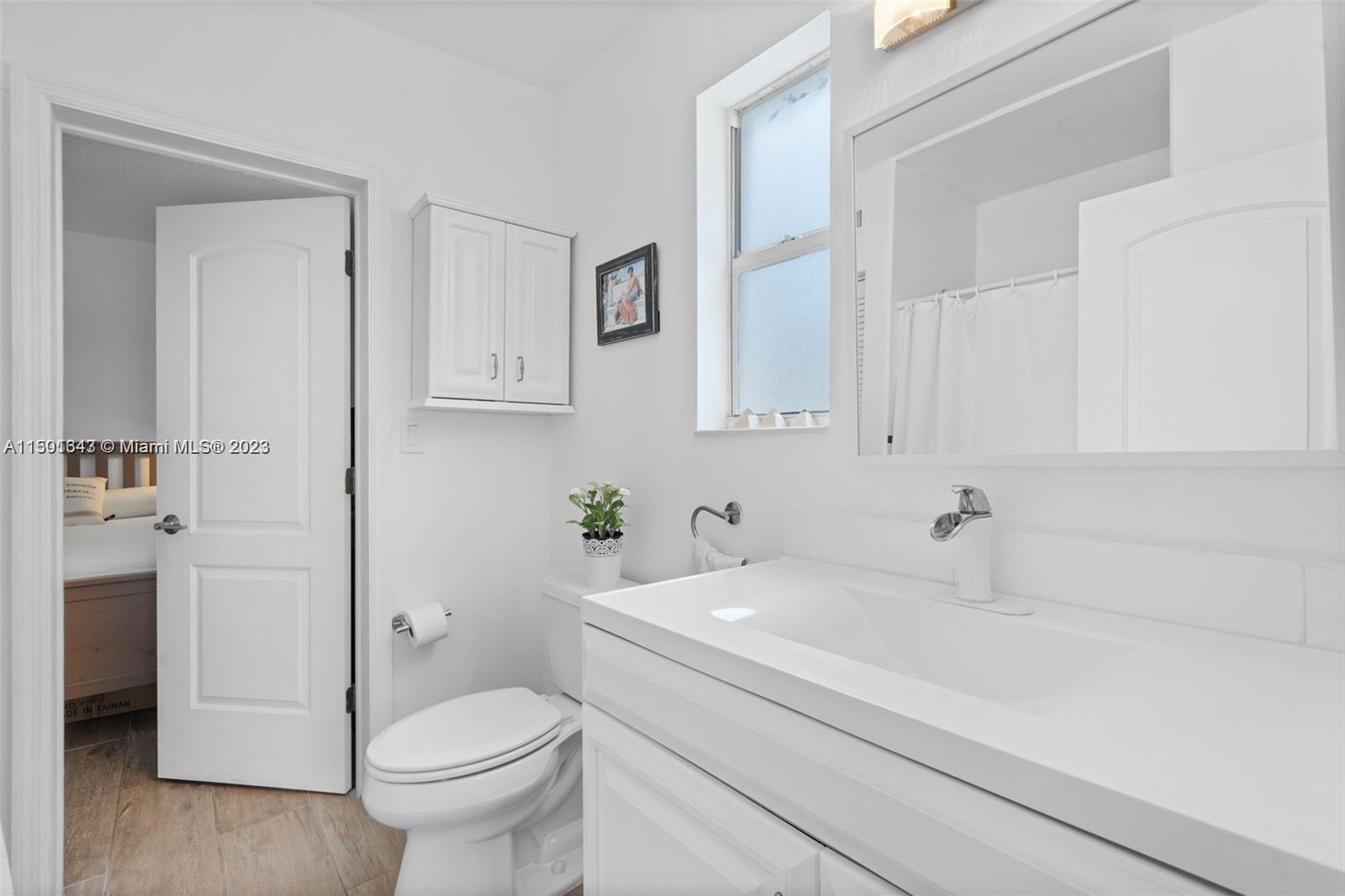 555 Northeast 70th Street Miami, FL 33138 - Photo 10 of 19 a bathroom with a sink toilet vanity and tub