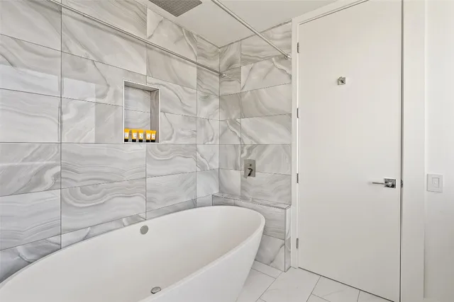 a bathroom with a bathtub and shower