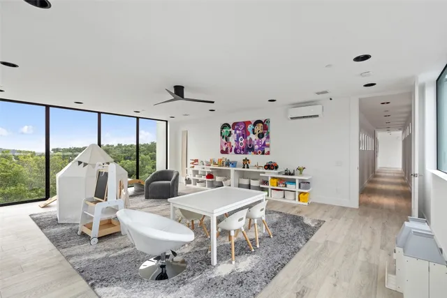 a living room with furniture and a floor to ceiling window