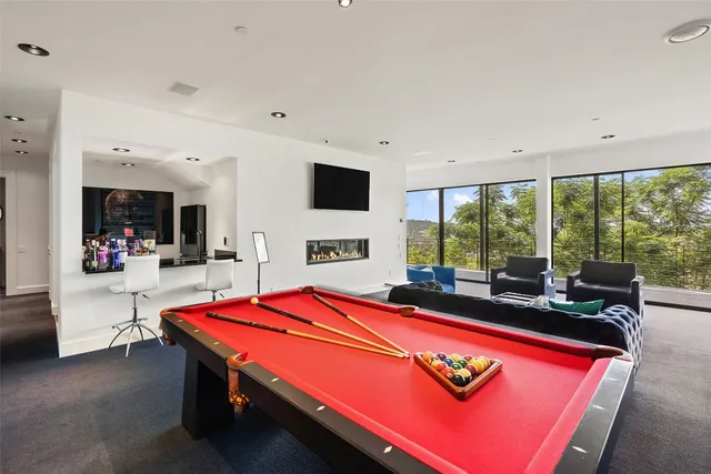 a room with pool table and flat screen tv