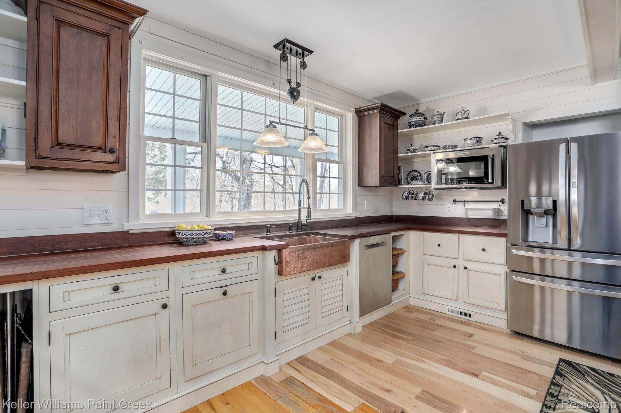 115 Michael Road Lapeer, MI 48446 - Photo 15 of 64 Plenty of Cabinetry, Open Shelving, Counter Space and Light to make this beautiful Modern Farmhouse Kitchen everyone's favorite gathering space