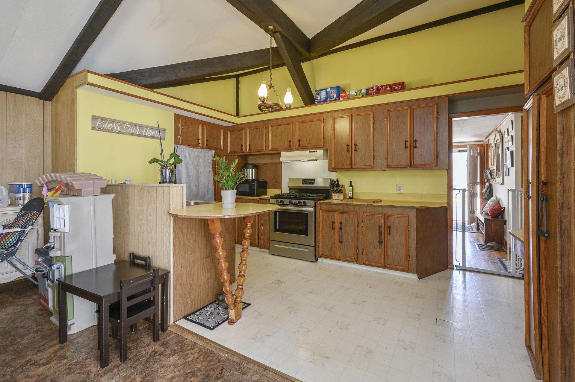358 Strawberry Hill Road Centerville, MA 02632 - Photo 9 of 25 a kitchen with stainless steel appliances kitchen island granite countertop a refrigerator a stove and a wooden cabinets