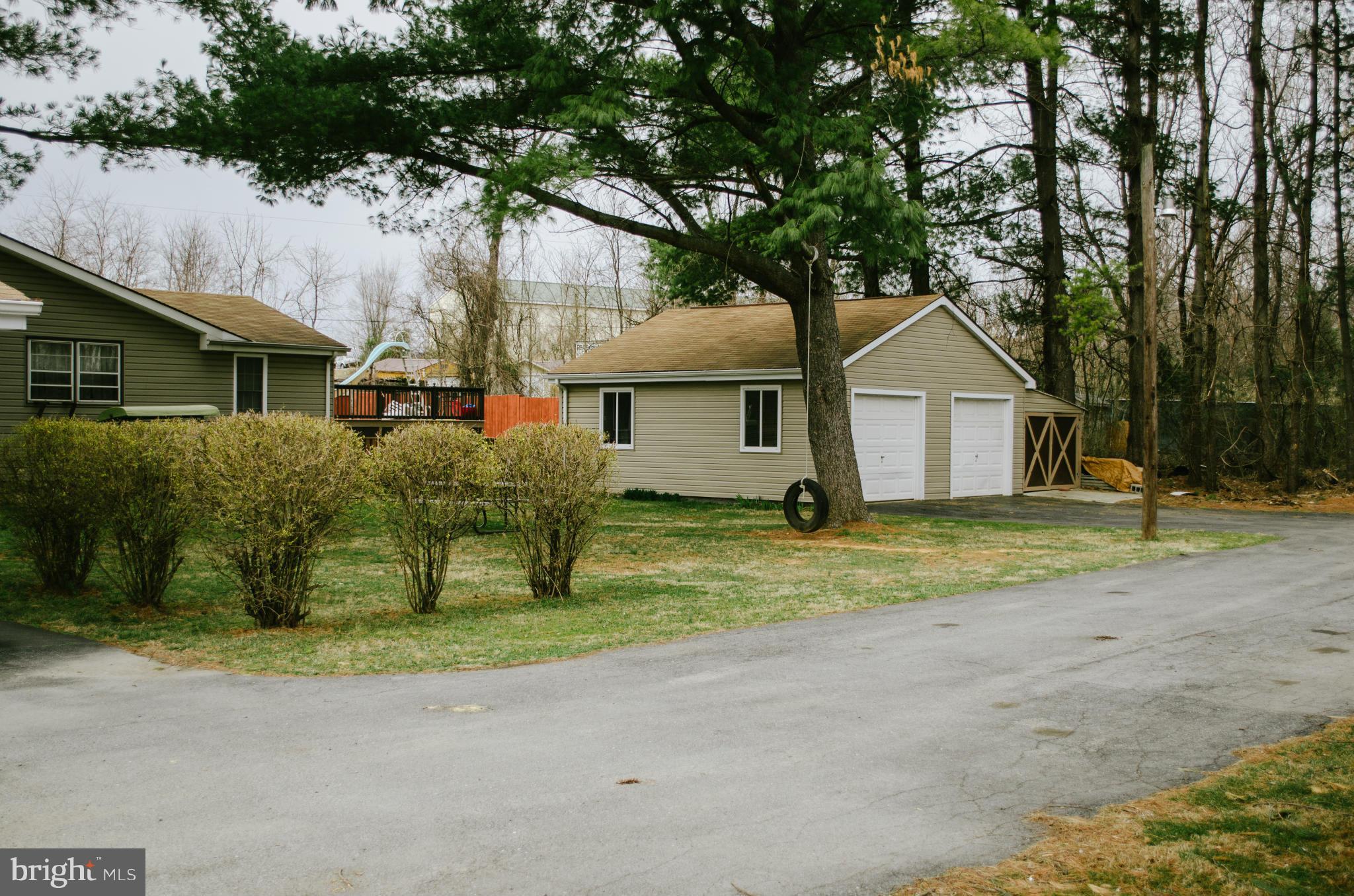 305 Algers Avenue Ranson, WV 25438 - Photo 2 of 30 a front view of a house with a yard and garage