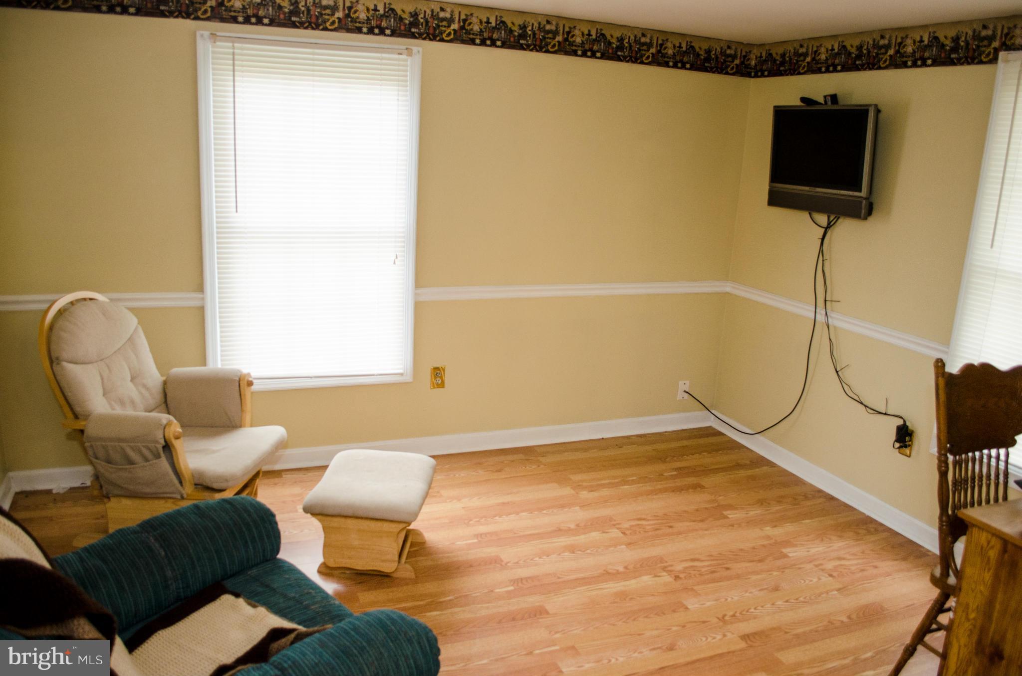 305 Algers Avenue Ranson, WV 25438 - Photo 13 of 30 a room with furniture and a flat screen tv