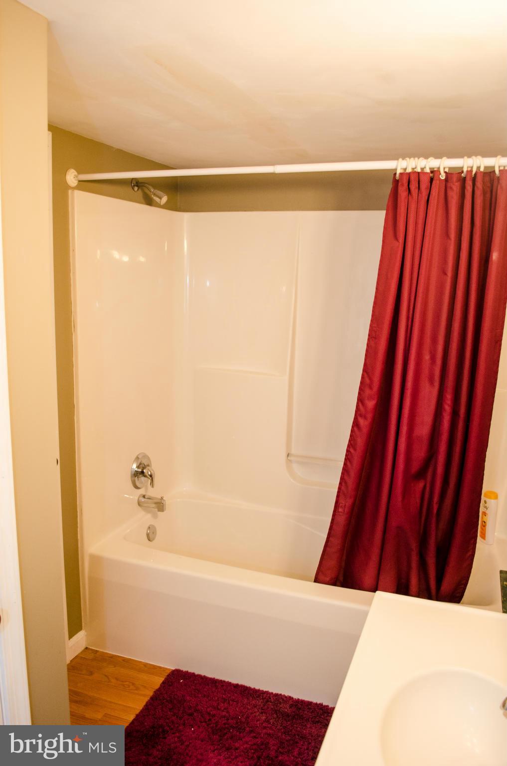 305 Algers Avenue Ranson, WV 25438 - Photo 17 of 30 a bathroom with a shower and a bath tub