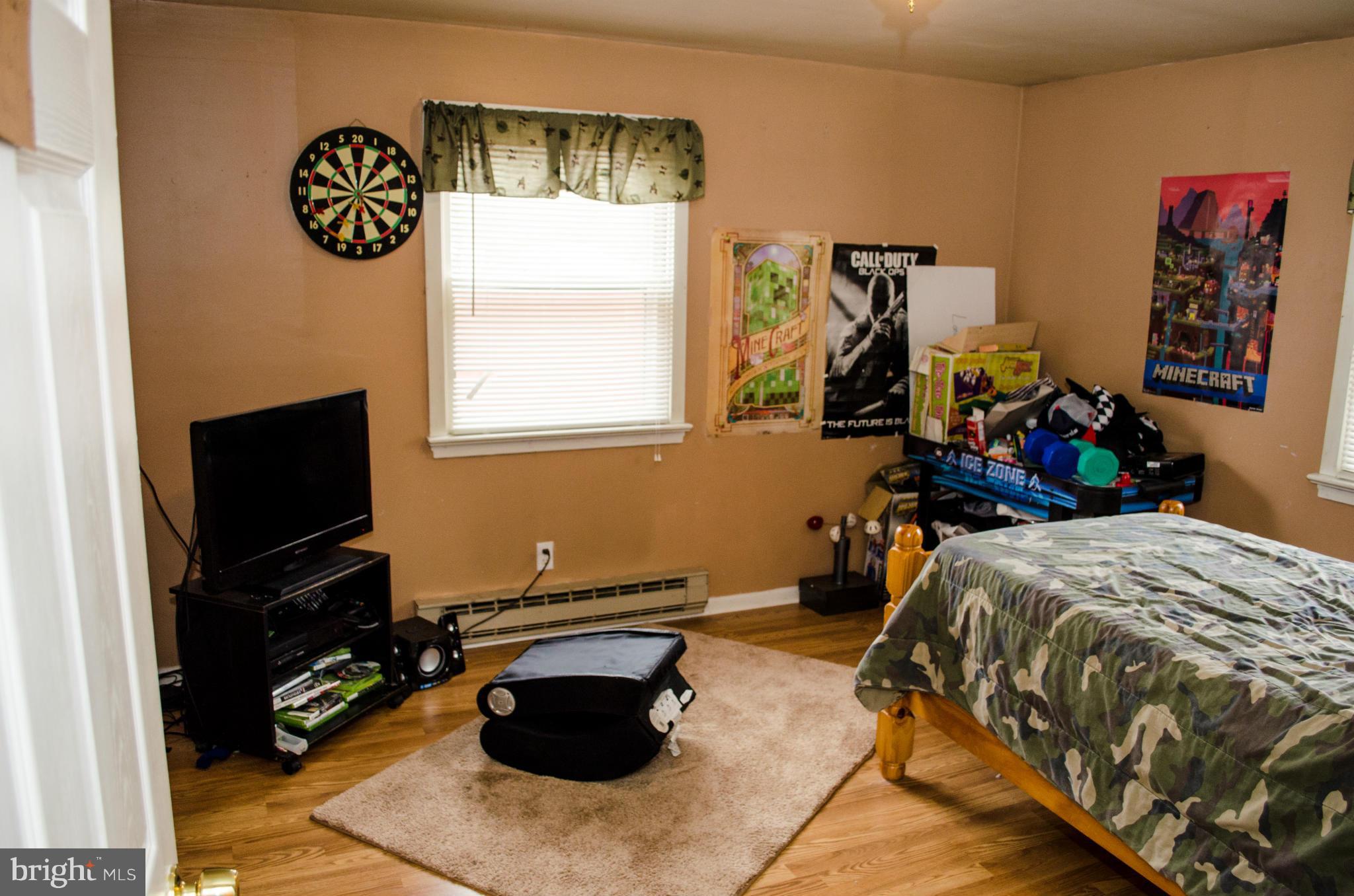 305 Algers Avenue Ranson, WV 25438 - Photo 23 of 30 a bedroom with bed and a flat tv screen on dresser