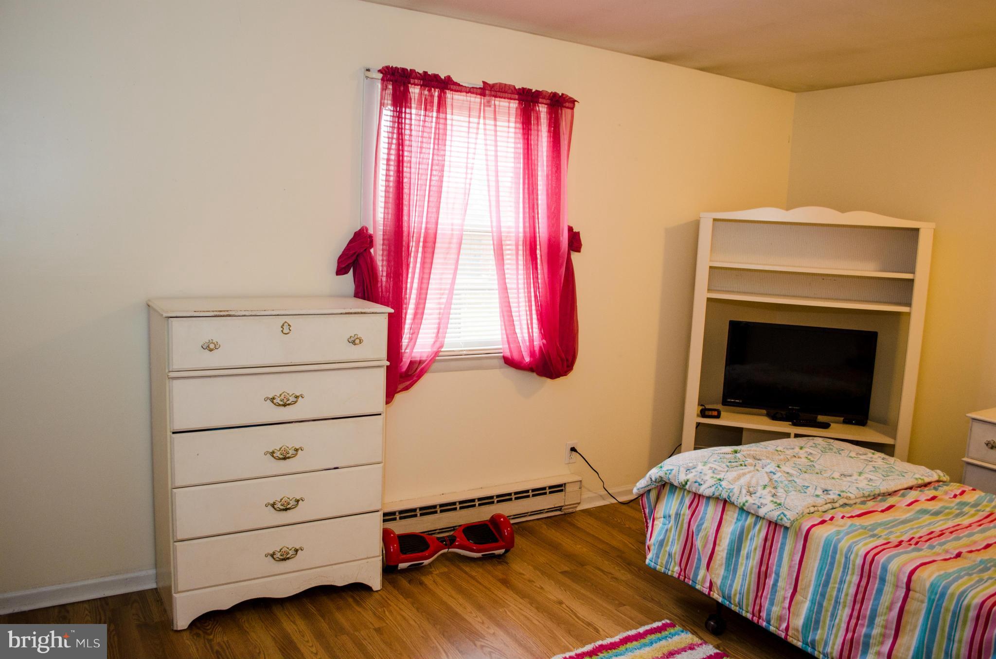 305 Algers Avenue Ranson, WV 25438 - Photo 24 of 30 a bedroom with a bed and a dresser