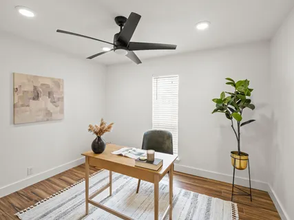 a living room with furniture and a potted plant