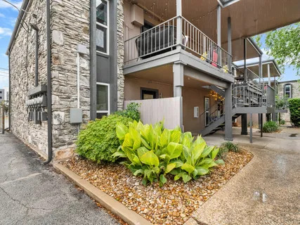 a front view of a multi story residential apartment building with yard