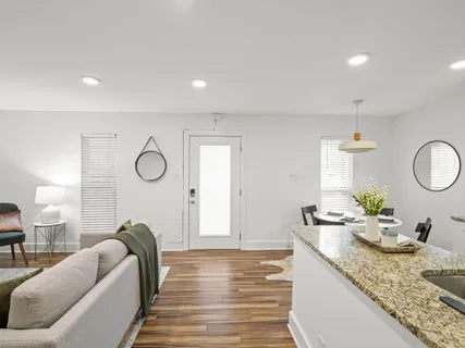 a living room with granite countertop furniture a mirror and a lamp