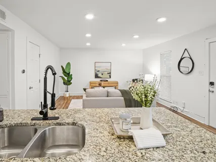 a living room with granite countertop furniture and a rug