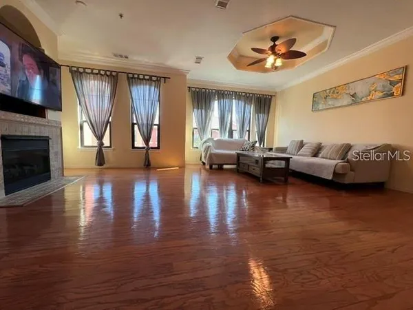 a living room with fireplace furniture and a wooden floor