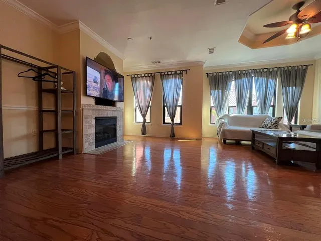 a living room with furniture window and wooden floor