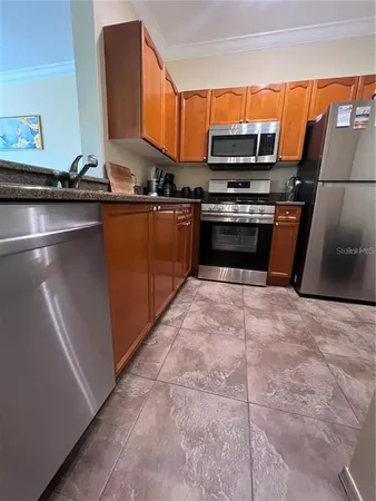 a kitchen with stainless steel appliances a stove a sink and a microwave