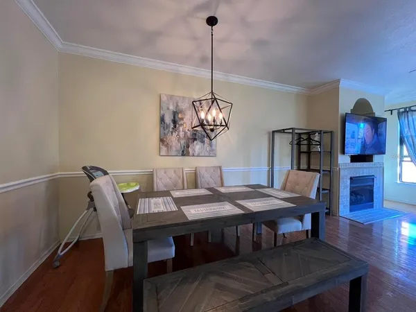 a view of a dining room with furniture wooden floor and chandelier