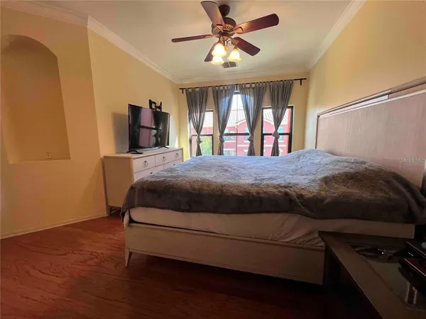 a bedroom with a bed dresser and a window