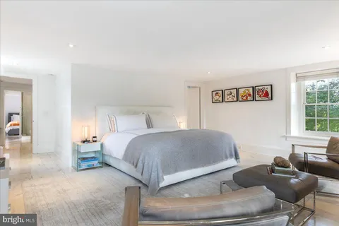a bedroom with a bed and a fireplace