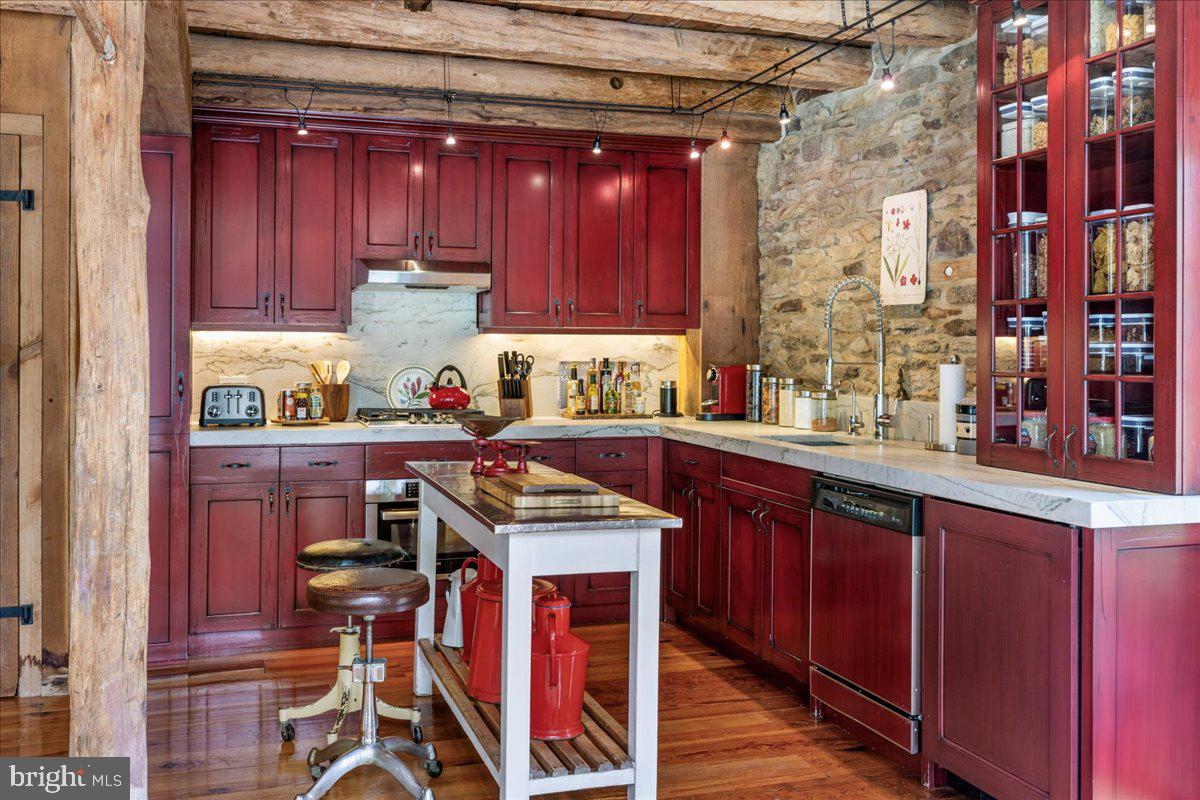 5966 Mechanicsville Road Doylestown, PA 18902 - Photo 36 of 89 a kitchen with stainless steel appliances granite countertop a stove a sink dishwasher and cabinets with wooden floor