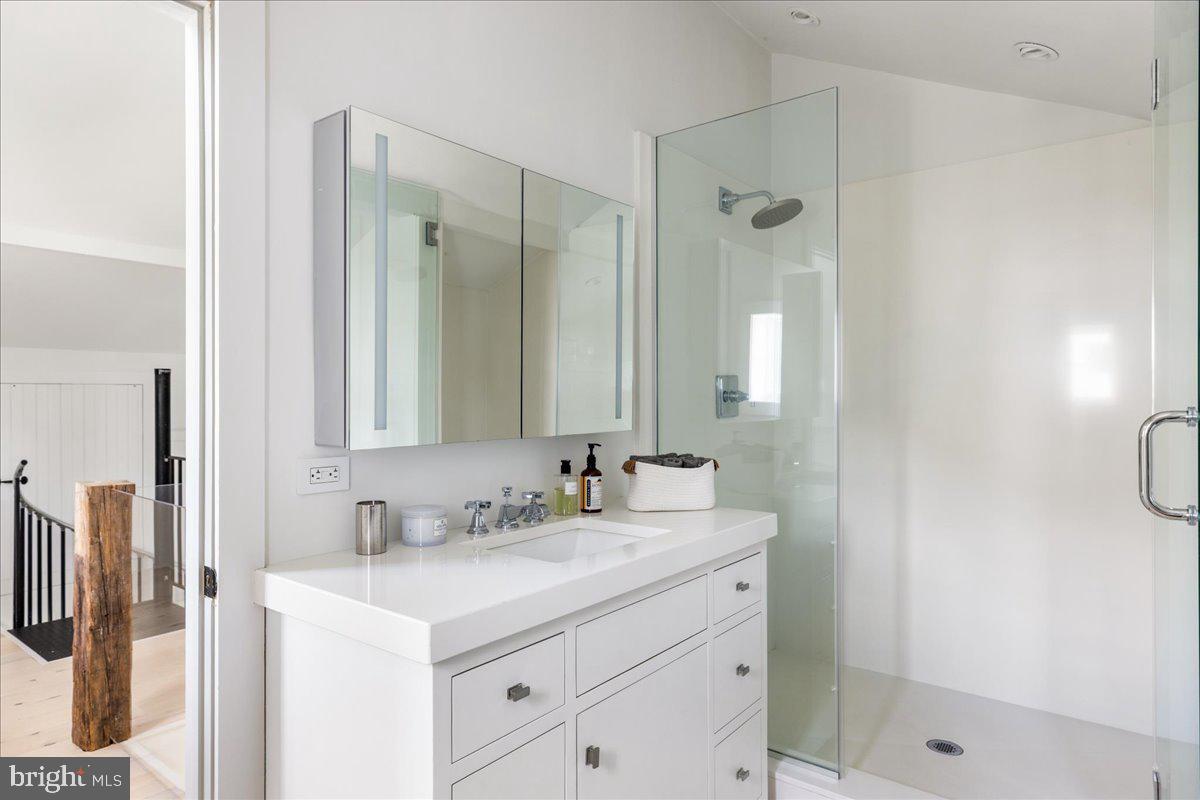5966 Mechanicsville Road Doylestown, PA 18902 - Photo 56 of 89 a bathroom with a shower sink vanity and mirror