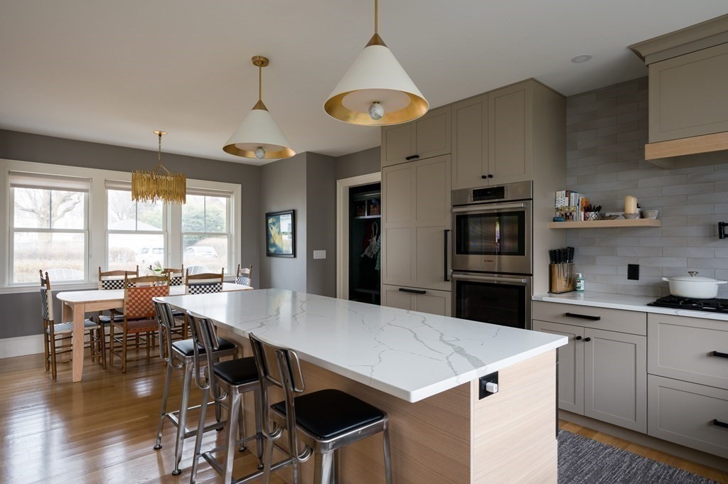 460 Main Street Hingham, MA 02043 - Photo 5 of 42 a kitchen with a table chairs stove and cabinets