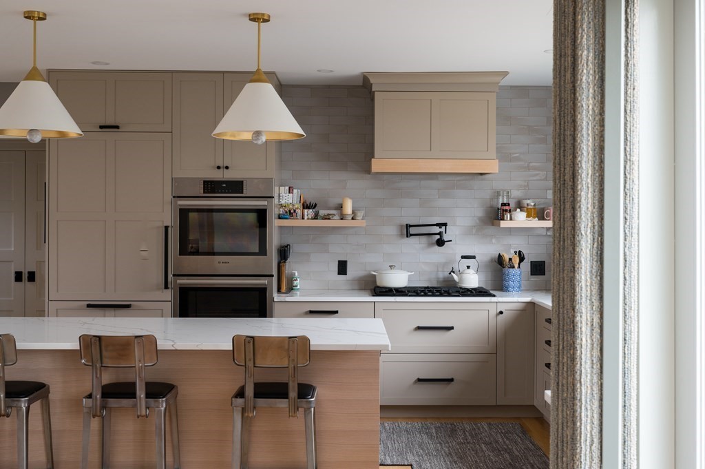 460 Main Street Hingham, MA 02043 - Photo 10 of 42 a kitchen with stainless steel appliances a stove a sink and cabinets