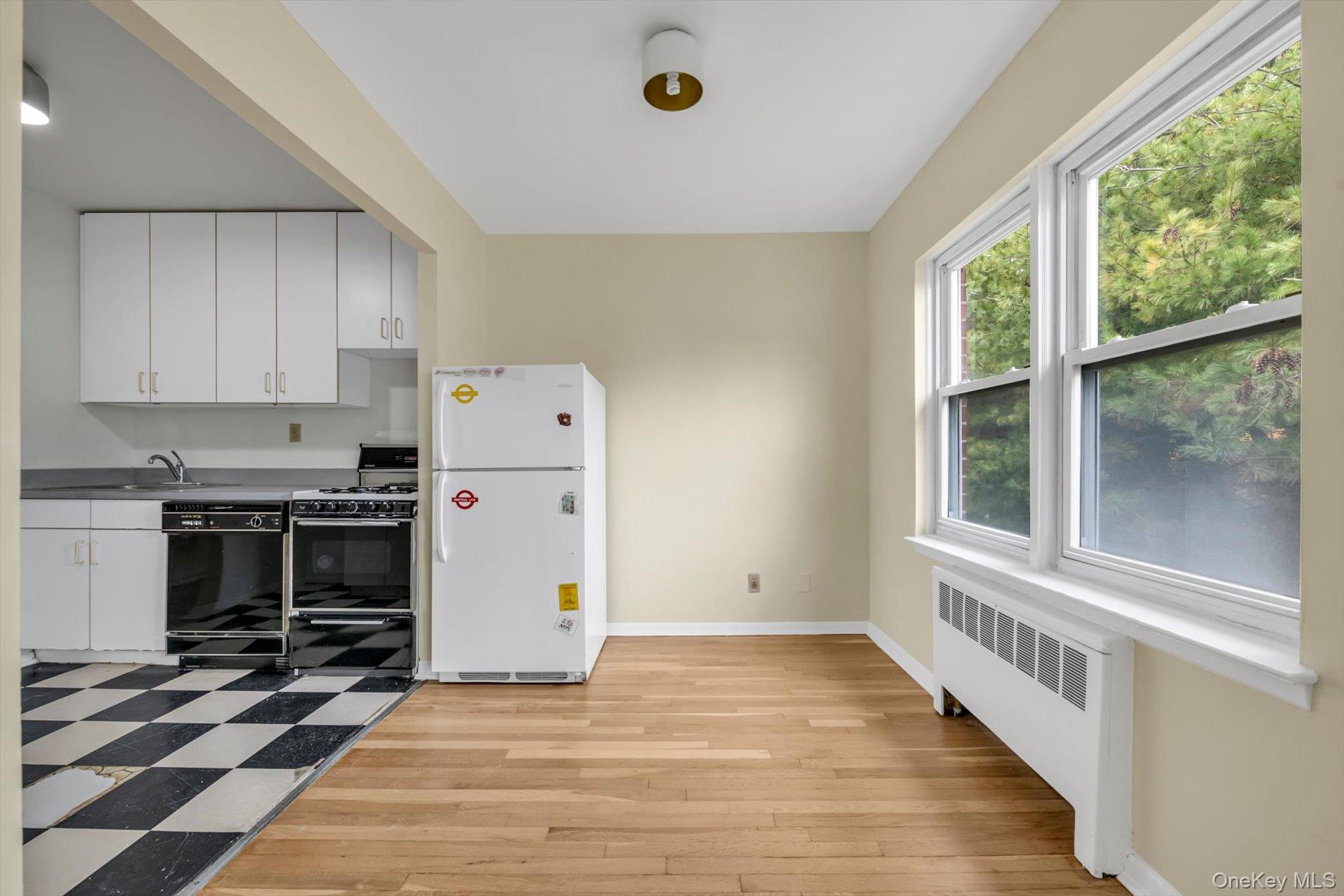 643 Pelham Road, Unit 6D New Rochelle, NY 10805 - Photo 6 of 12 a view of a kitchen with a stove cabinets and a floor to ceiling window