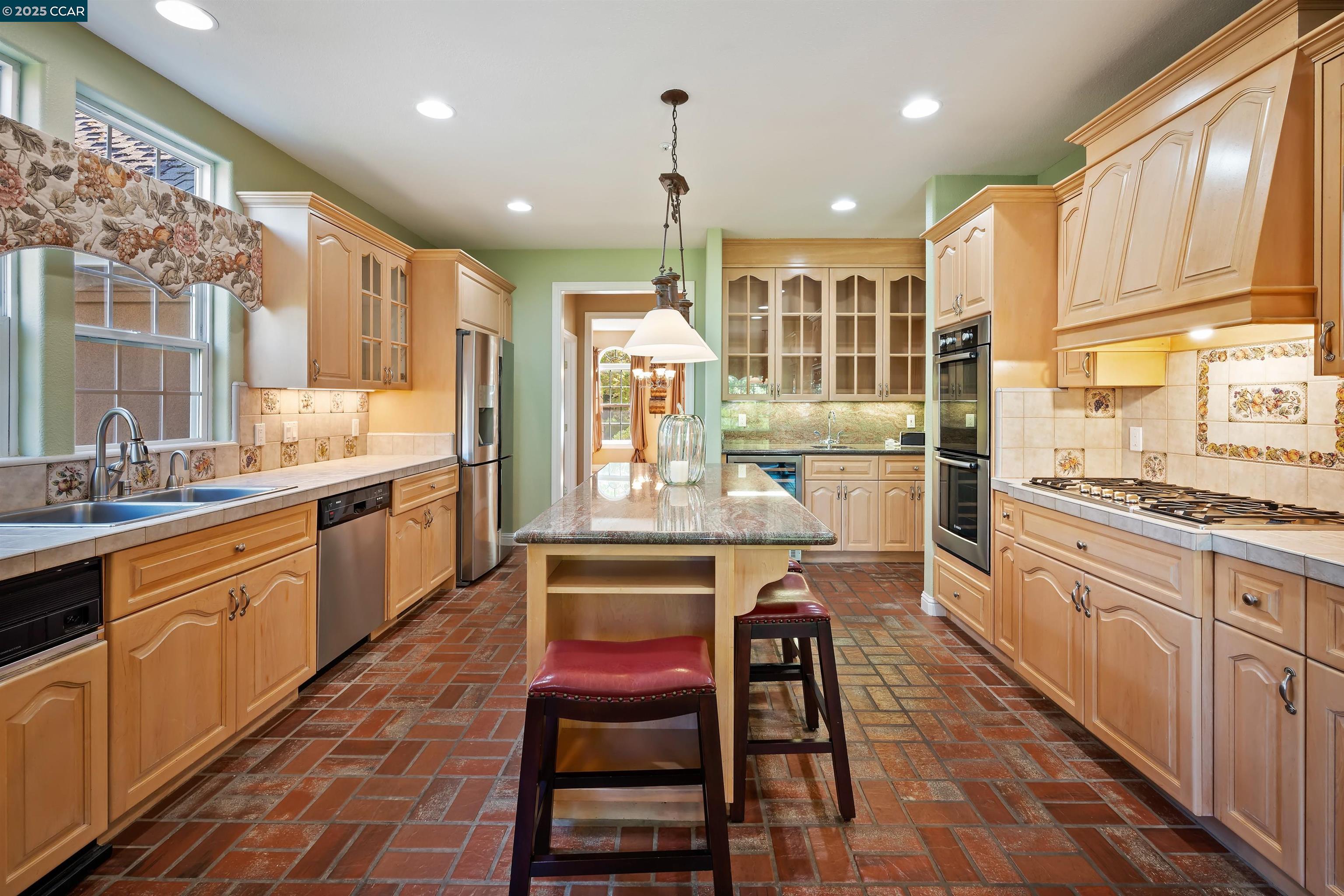 20 Oak Crest Lane Alamo, CA 94507 - Photo 11 of 41 a large kitchen with a table and chairs in it