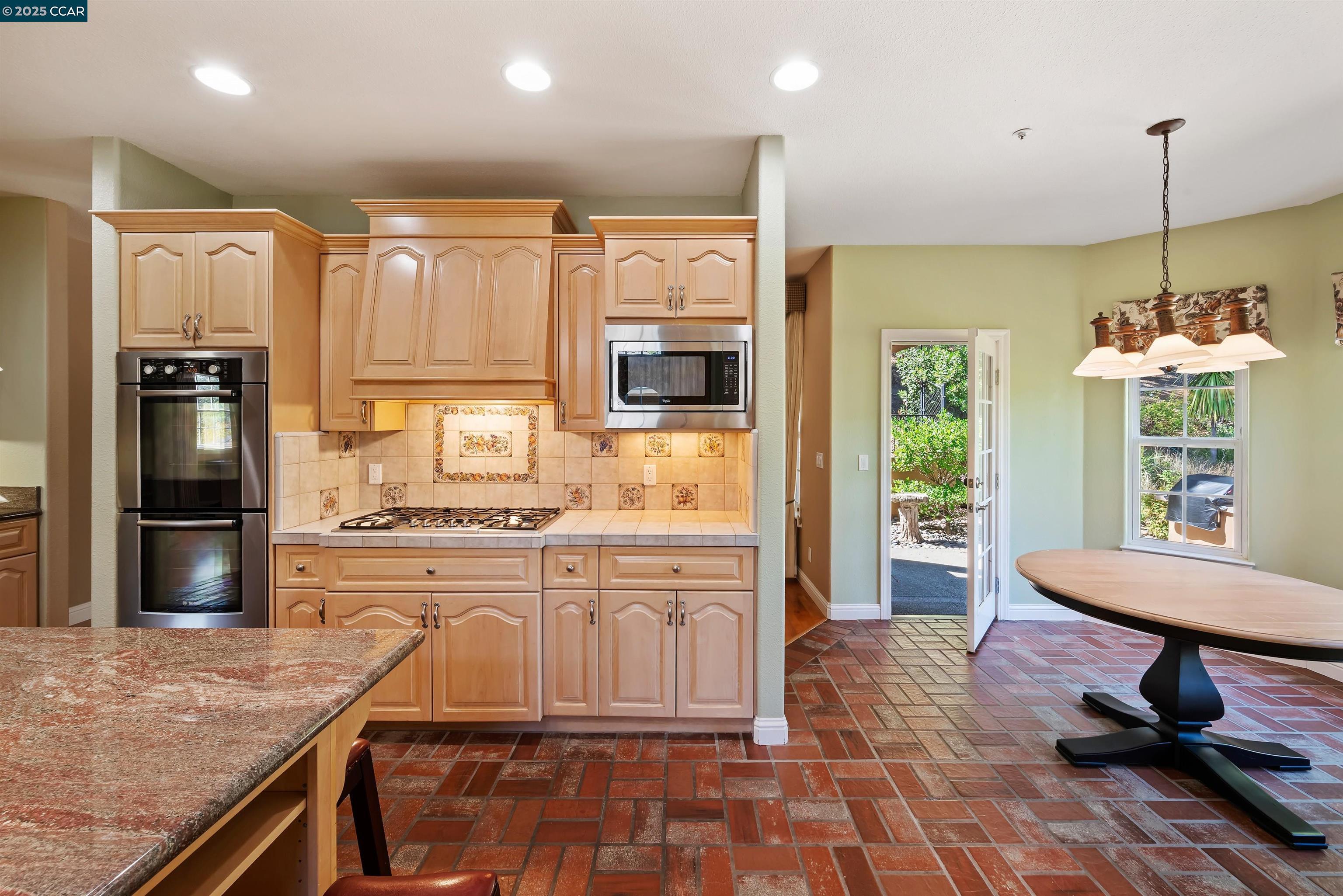 20 Oak Crest Lane Alamo, CA 94507 - Photo 13 of 41 a kitchen with kitchen island granite countertop a stove a sink and a refrigerator