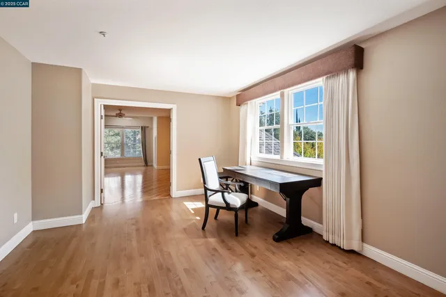a dining room with furniture and wooden floor