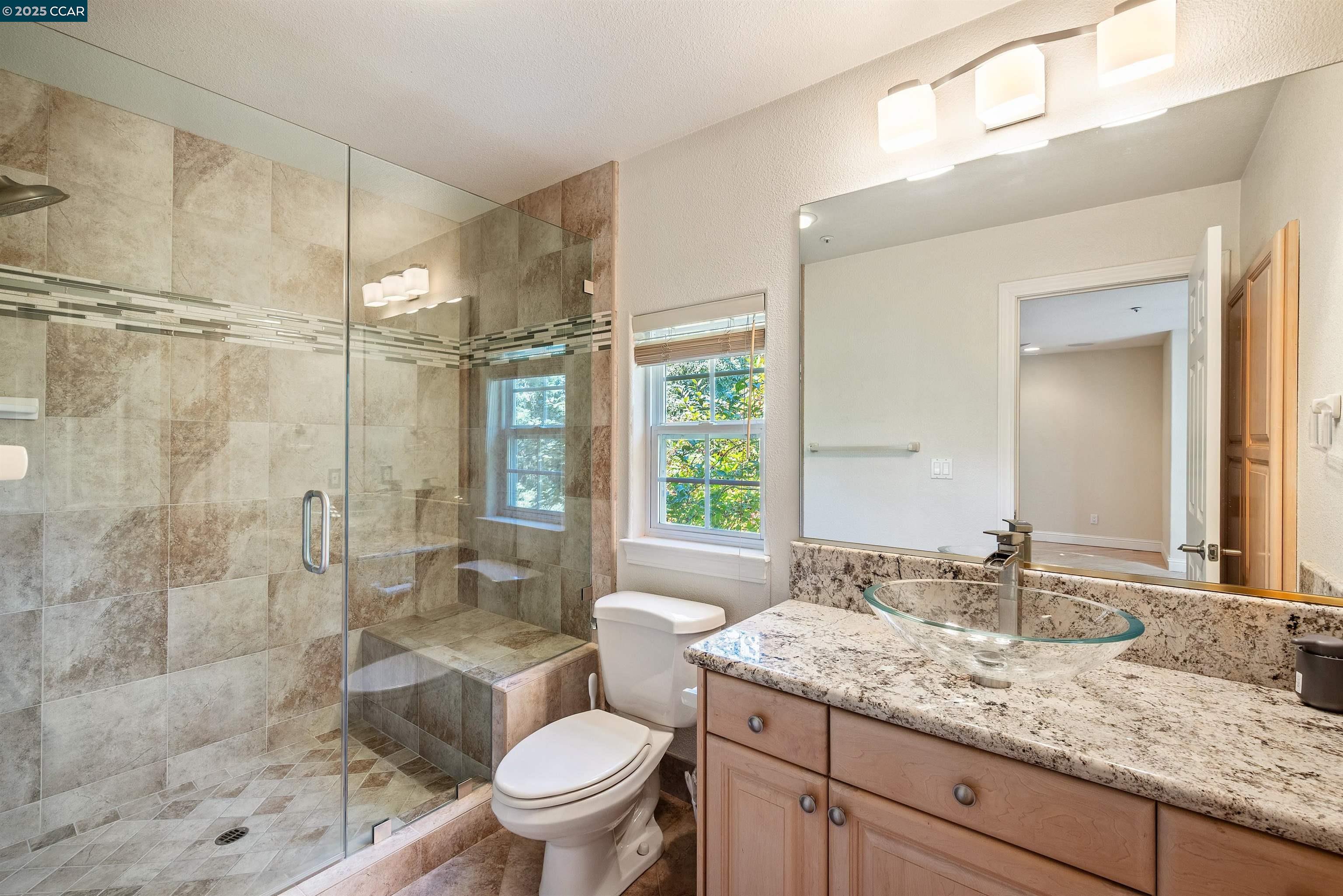 20 Oak Crest Lane Alamo, CA 94507 - Photo 20 of 41 a bathroom with a granite countertop sink toilet and shower