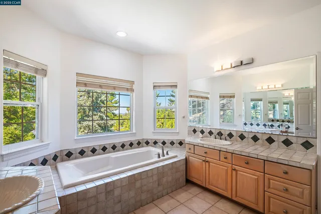 a large spacious bathroom with a bathtub and a sink