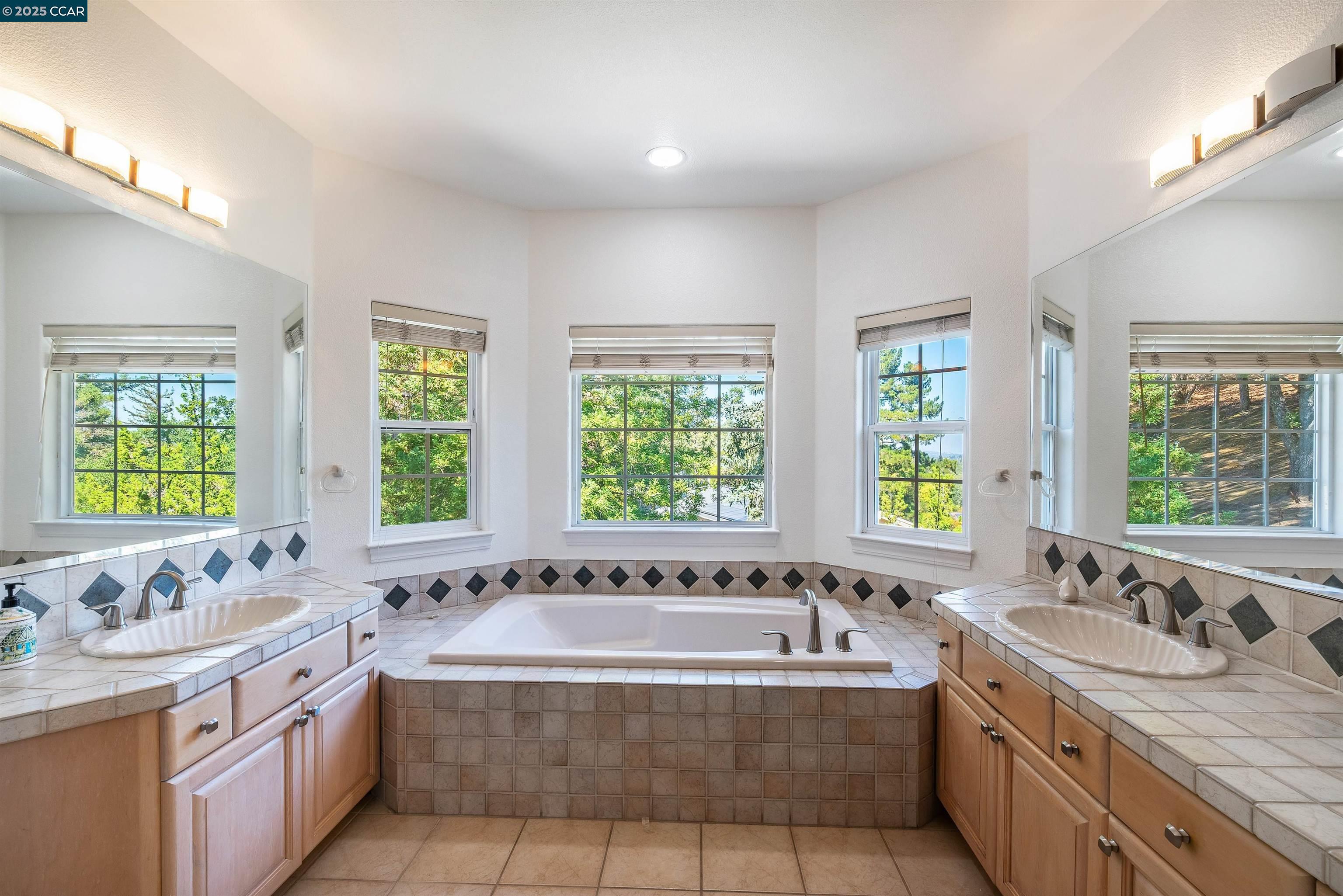 20 Oak Crest Lane Alamo, CA 94507 - Photo 27 of 41 a bathroom with a granite countertop tub and a sink