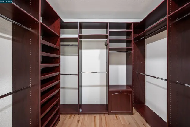 a view of walk in closet with empty racks