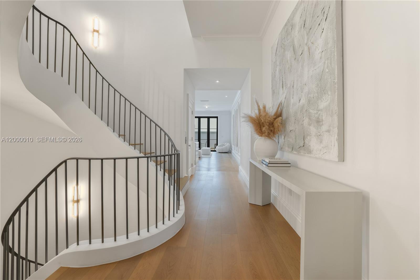 2617 Anderson Road Coral Gables, FL 33134 - Photo 12 of 49 a view of staircase and kitchen with wooden floor