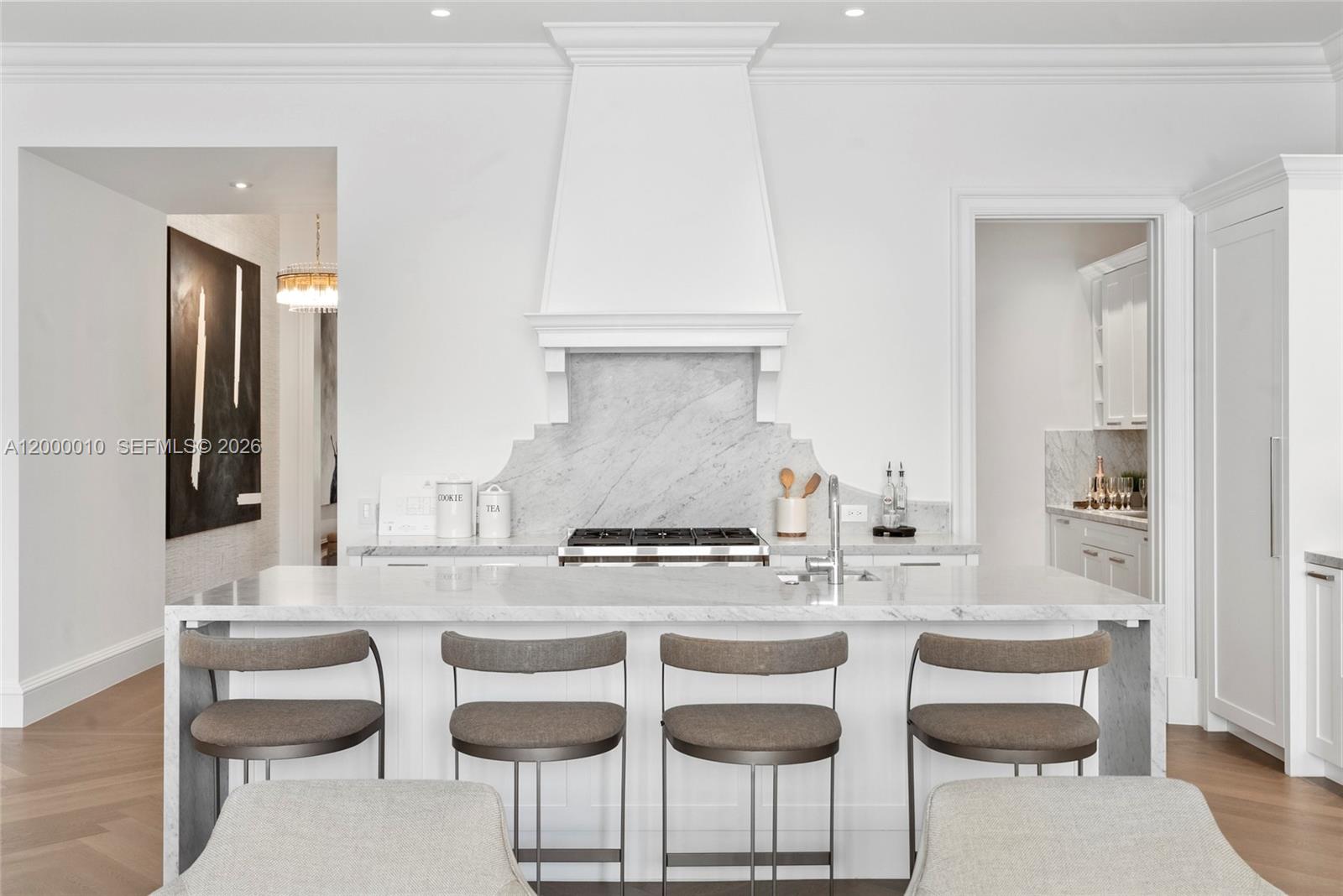 2617 Anderson Road Coral Gables, FL 33134 - Photo 19 of 49 a kitchen with a dining table chairs and white cabinets
