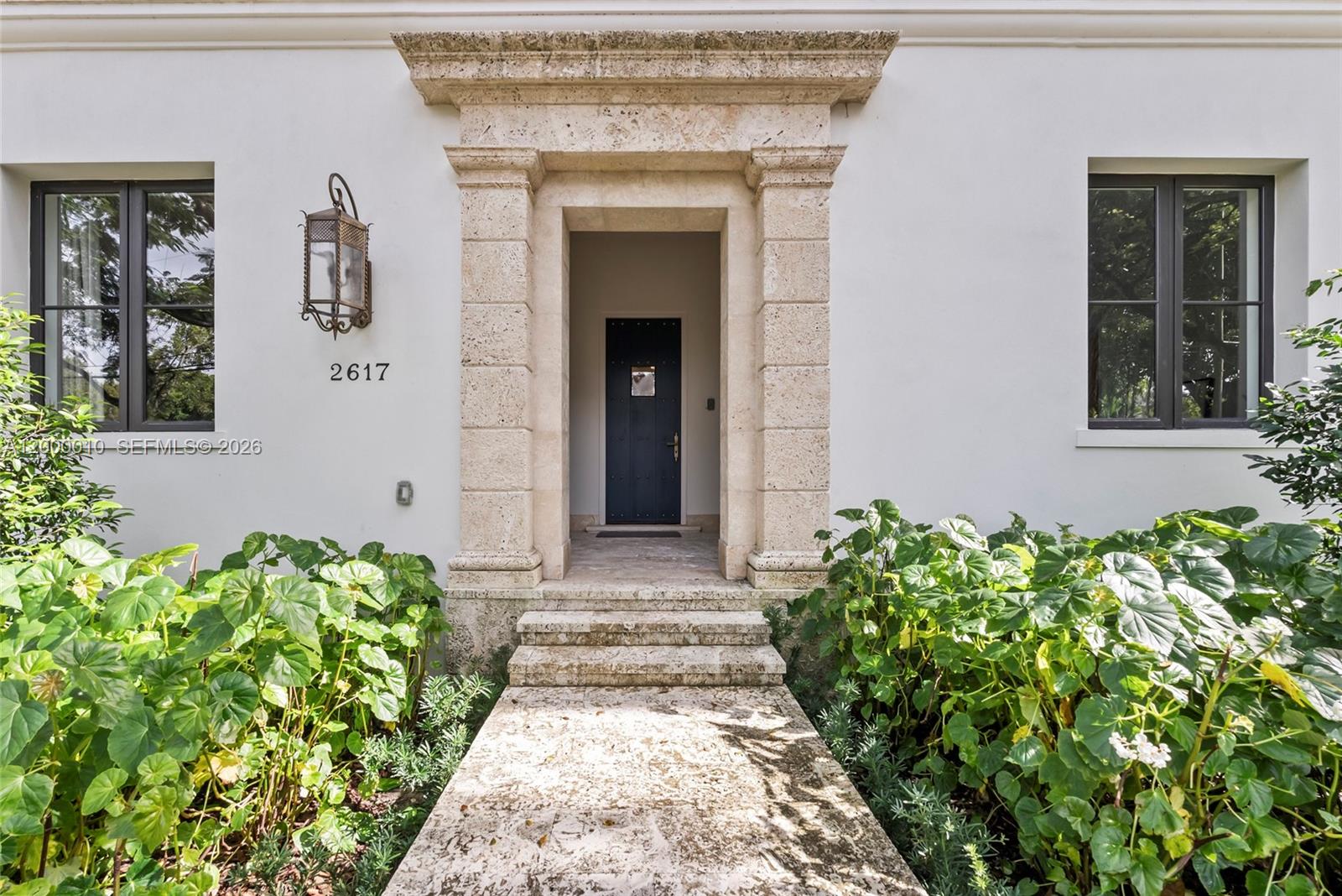 2617 Anderson Road Coral Gables, FL 33134 - Photo 2 of 49 a front view of a house with a blue plant