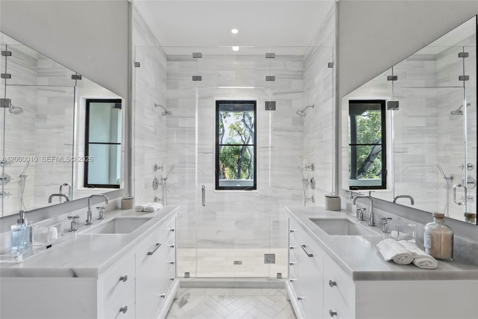 2617 Anderson Road Coral Gables, FL 33134 - Photo 41 of 49 a bathroom with double vanity sinks a large mirror and a bathtub