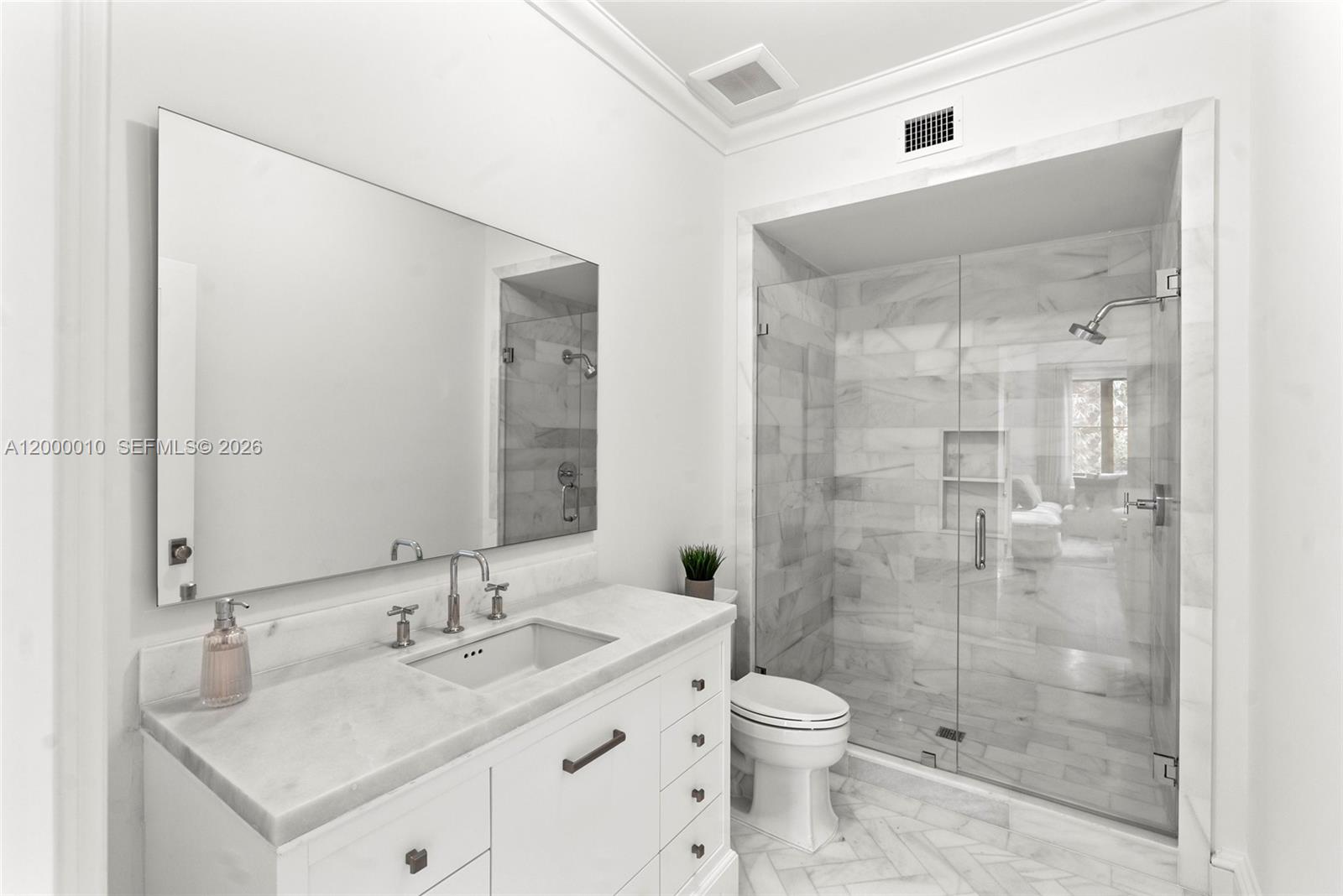 2617 Anderson Road Coral Gables, FL 33134 - Photo 8 of 49 a bathroom with a granite countertop sink toilet a mirror and shower