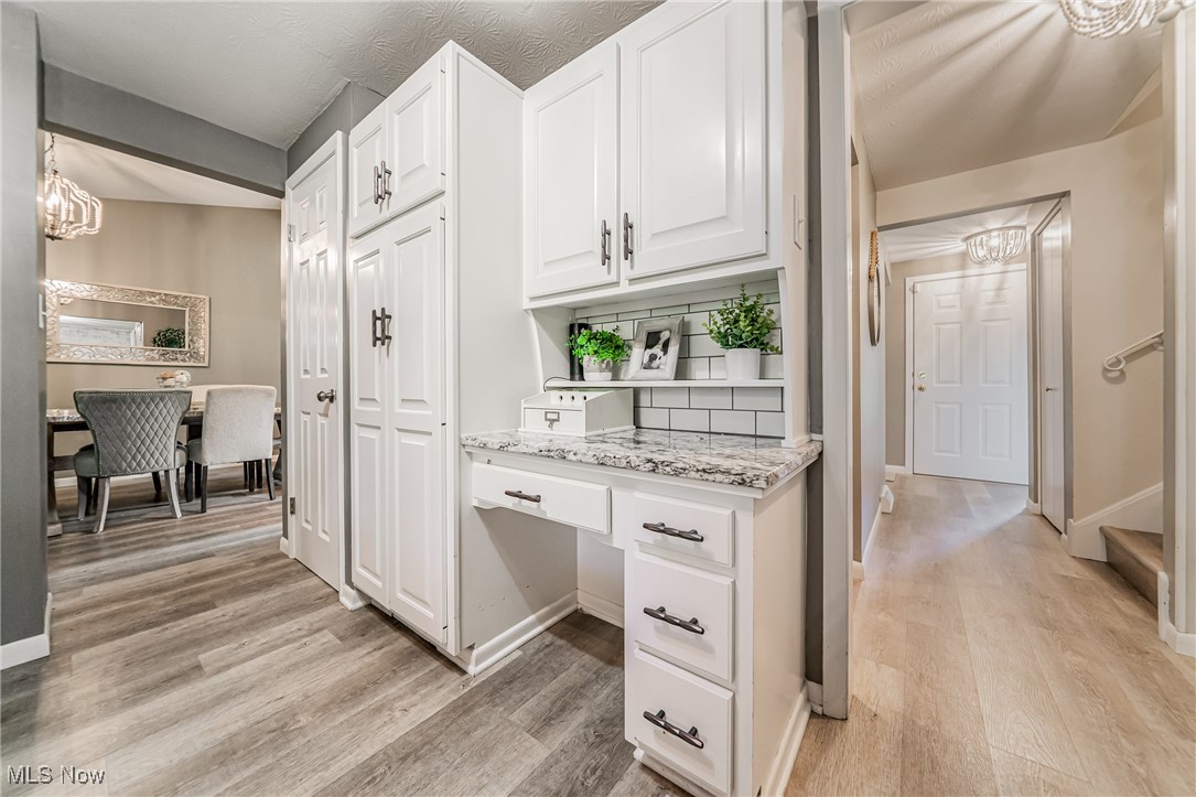 595 Moorfield Road Fairlawn, OH 44313 - Photo 9 of 50 Kitchen with a chandelier, white cabinetry, and light wood-style flooring