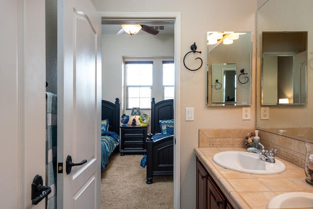 a bathroom with a sink double vanity and a mirror