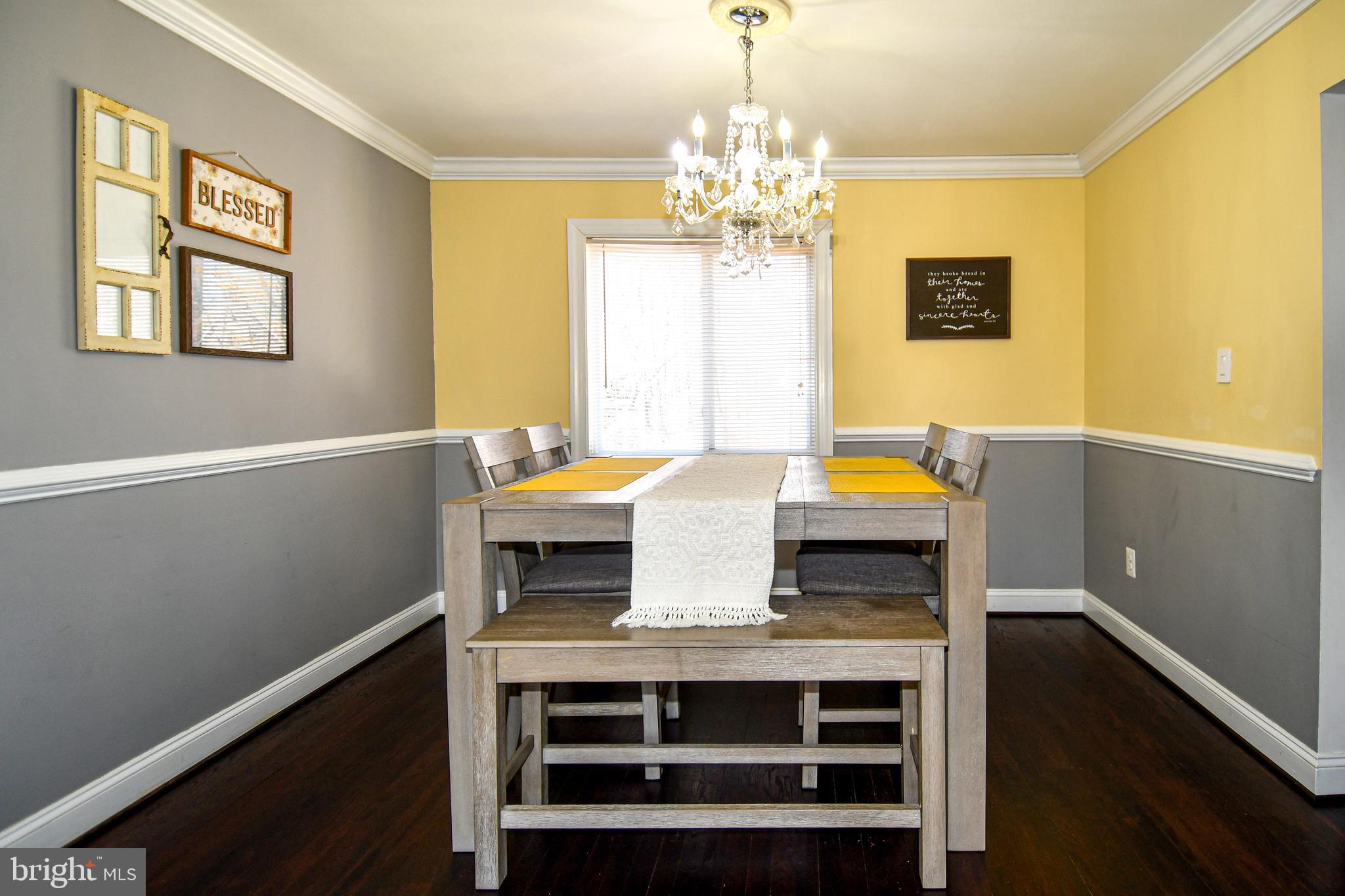 12604 Dulcinea Place Woodbridge, VA 22192 - Photo 12 of 63 a view of a dining room with furniture and chandelier